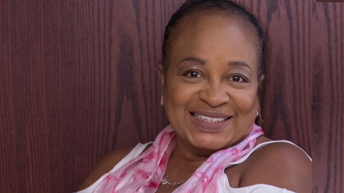 Roberta "Bobbi" Albany smiles as she leans against a wall
