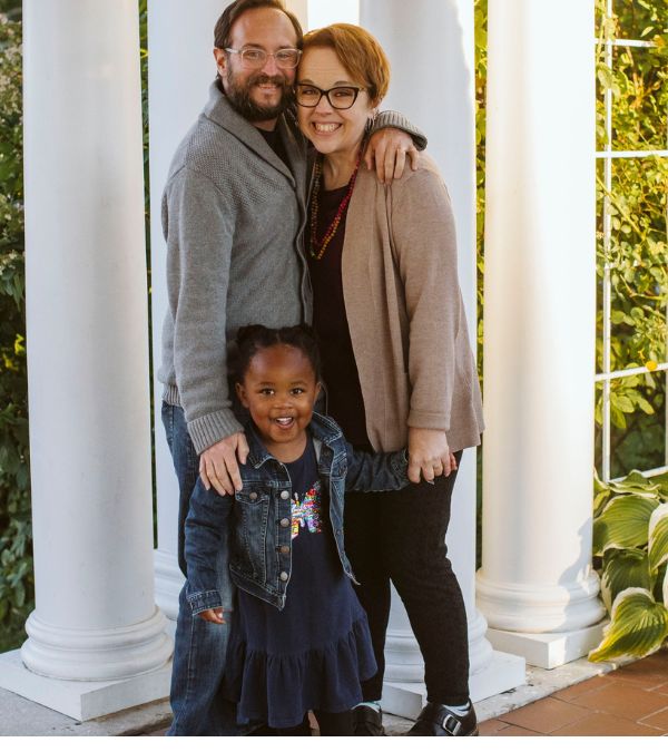 Four years together as a family, Liz and her husband, Jarrett, and their 4-year old daughter celebrate the occasion in a garden.