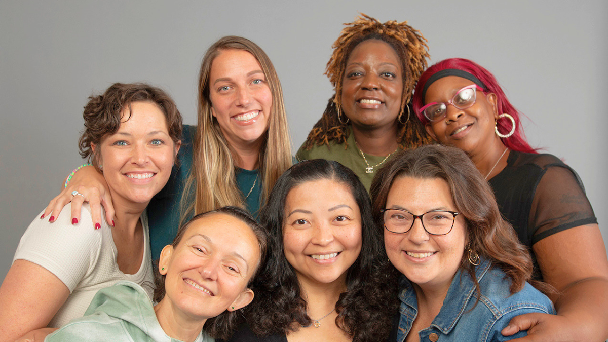 A diverse group of young women with MBC embracing each other