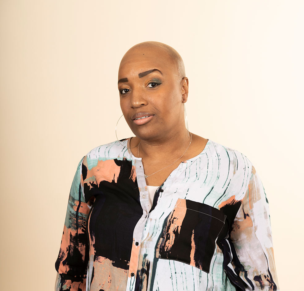 Keneene, a young Black woman with a shaved head
