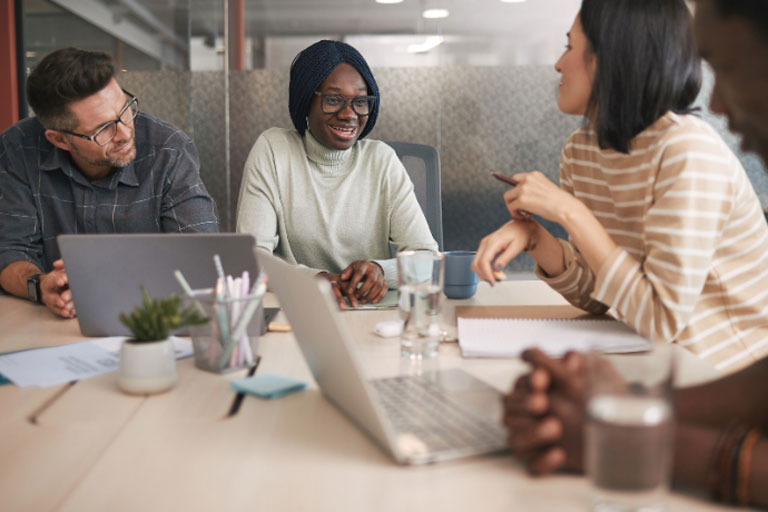 Woman at work in meeting with co-workers