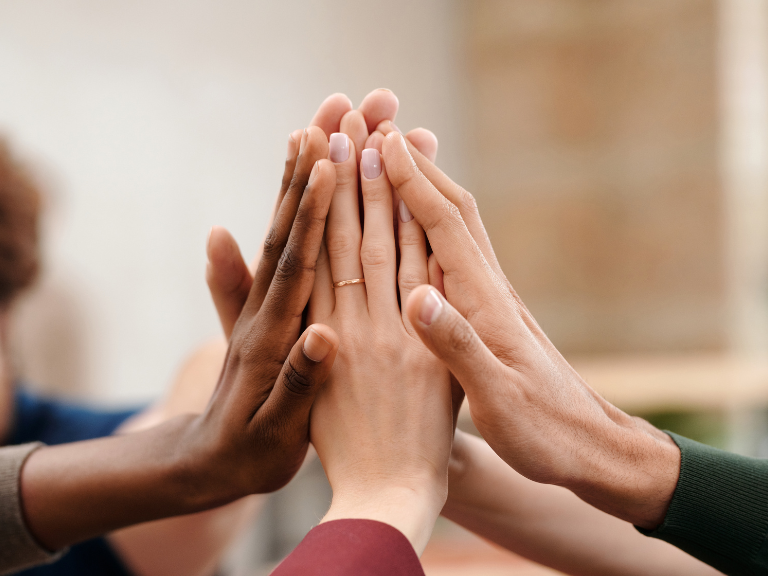 group of diverse hands in unity