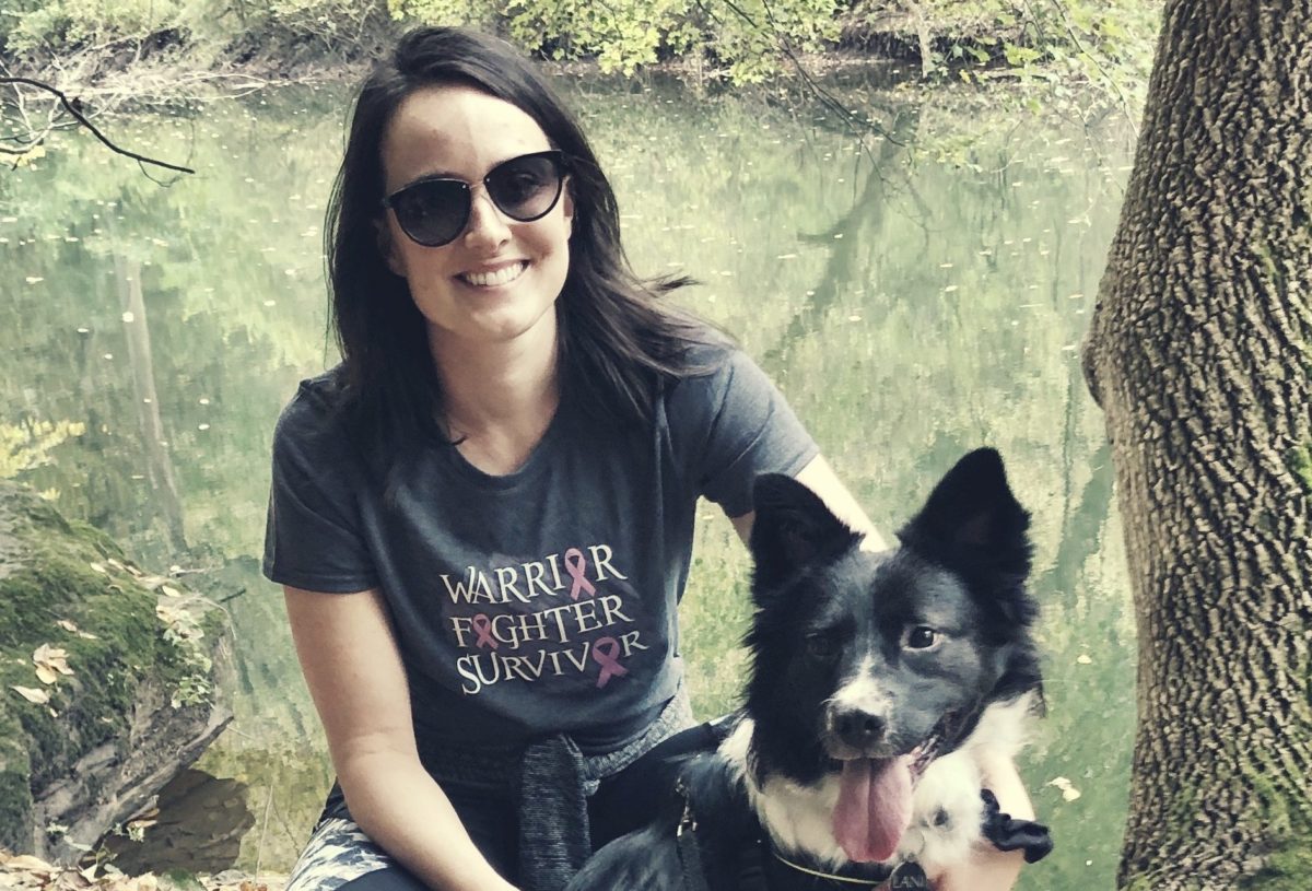 Shea with her dog, smiling, happy, enjoying the outdoors