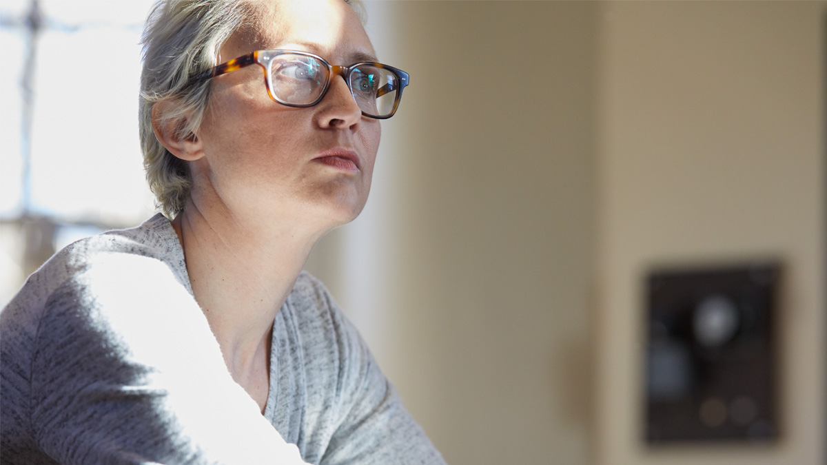 A woman with metastatic breast cancer looks out a window