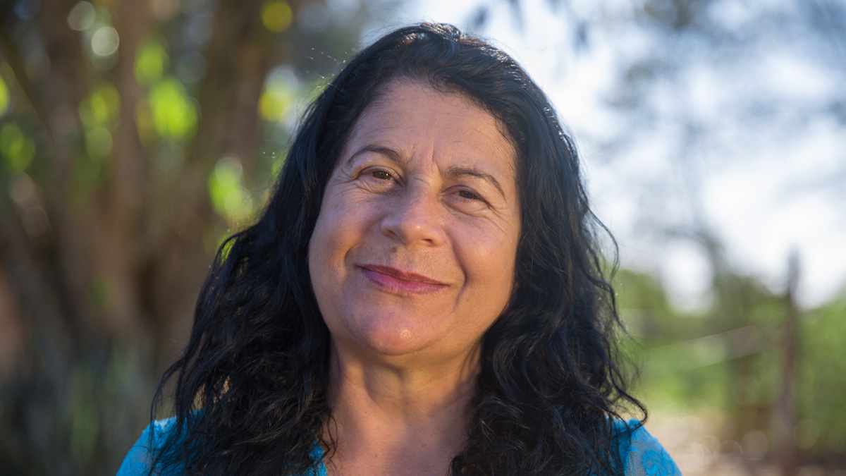 An older white woman smiling outside