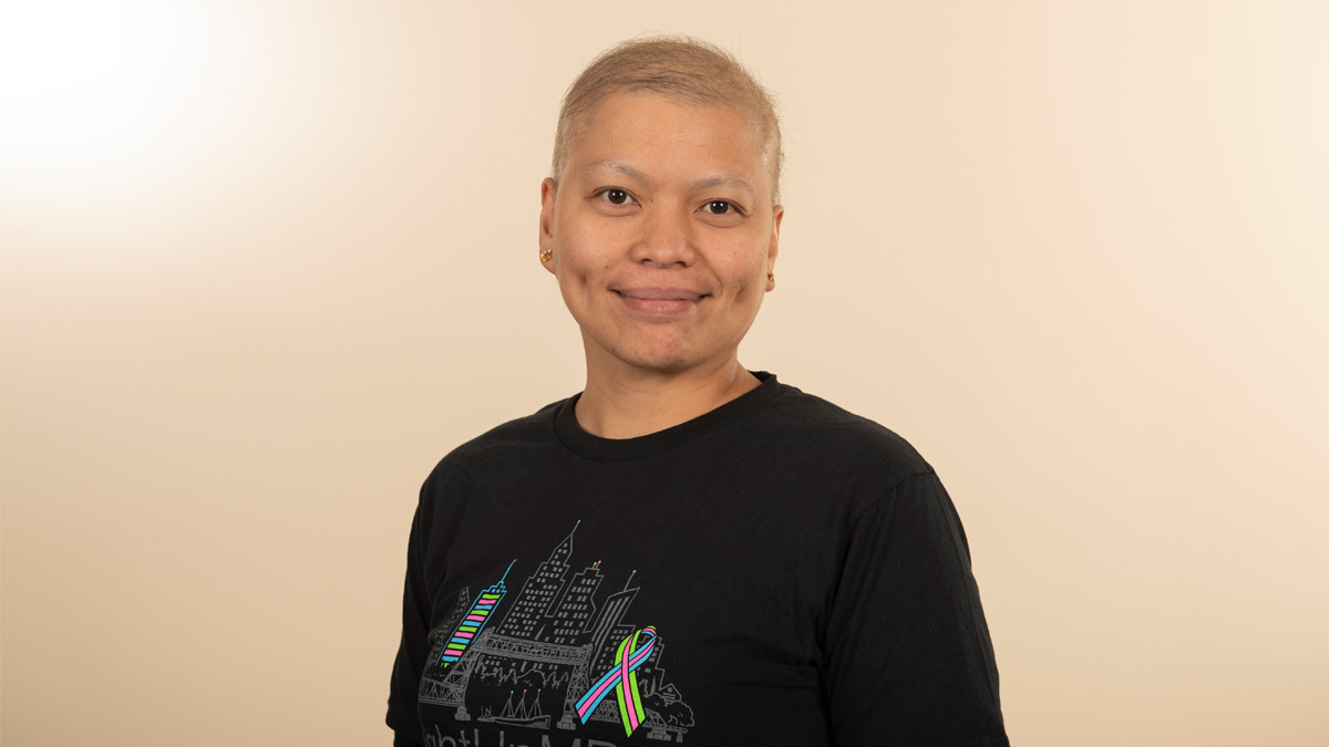 An Asian woman smiling.