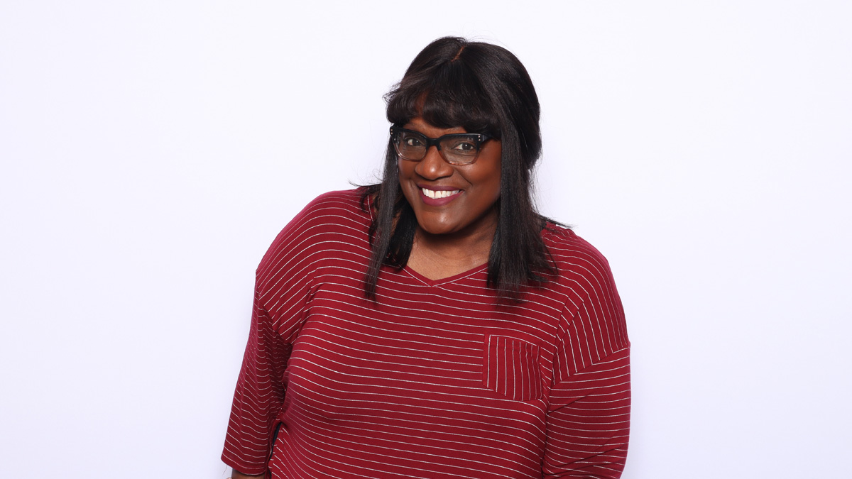 A Black woman smiling.