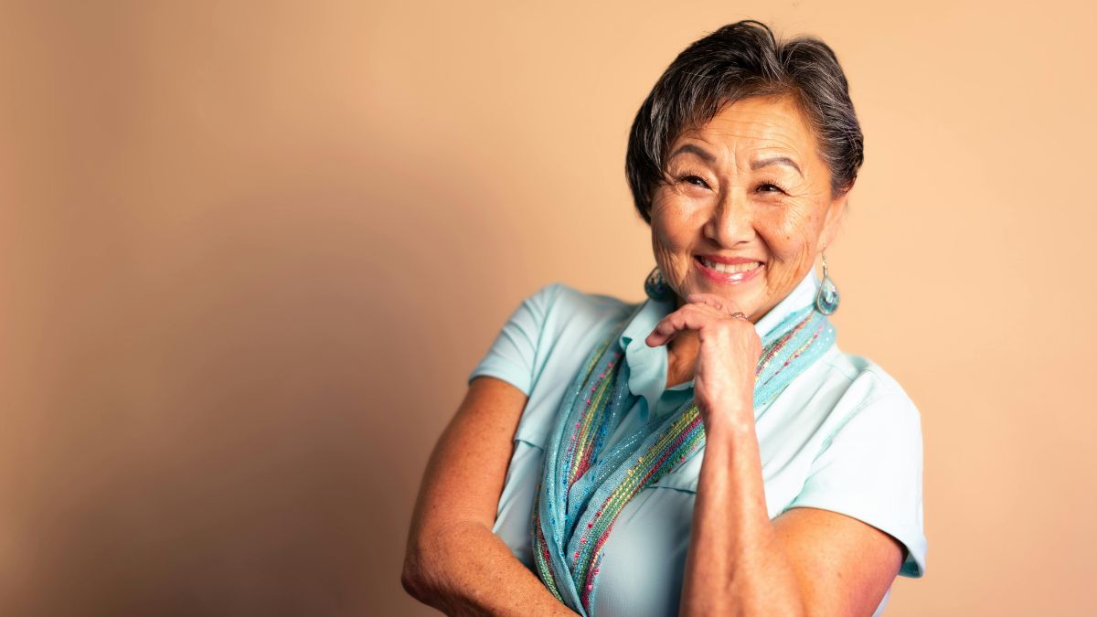 An older Asian woman smiling