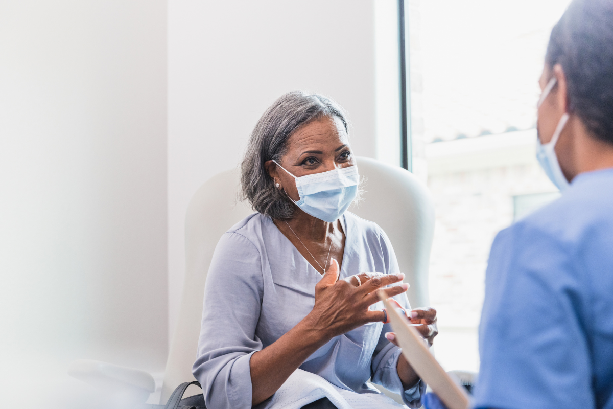 Woman talking to doctor