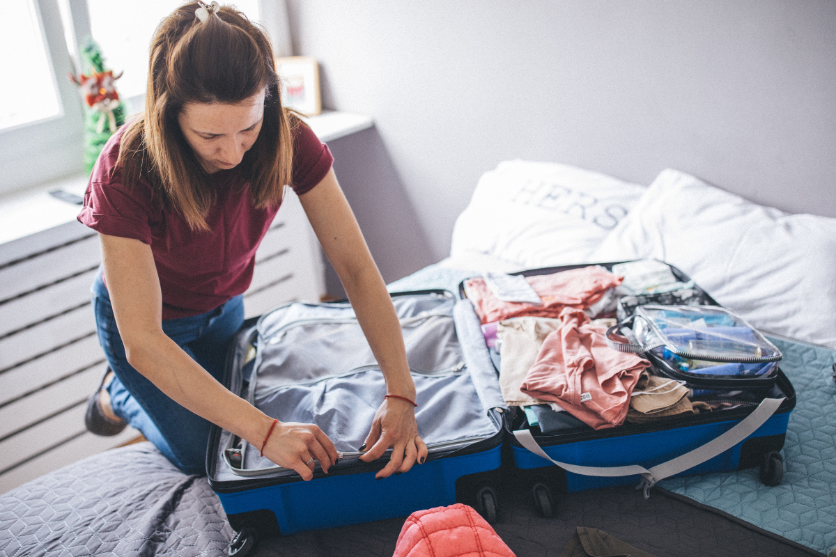 Woman packing suitcase