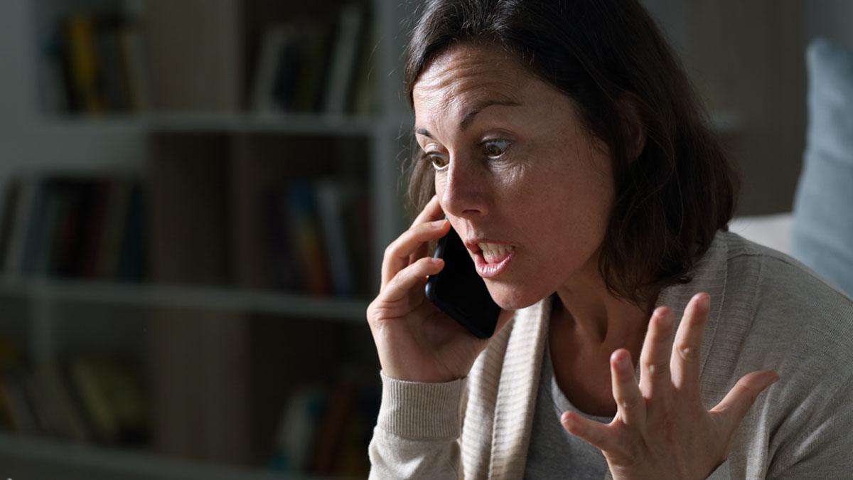 Frustrated woman on phone talking