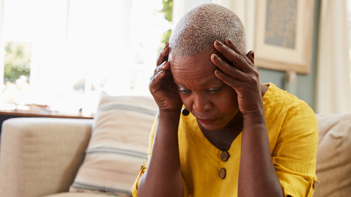 Black woman with hands on head in disbelief