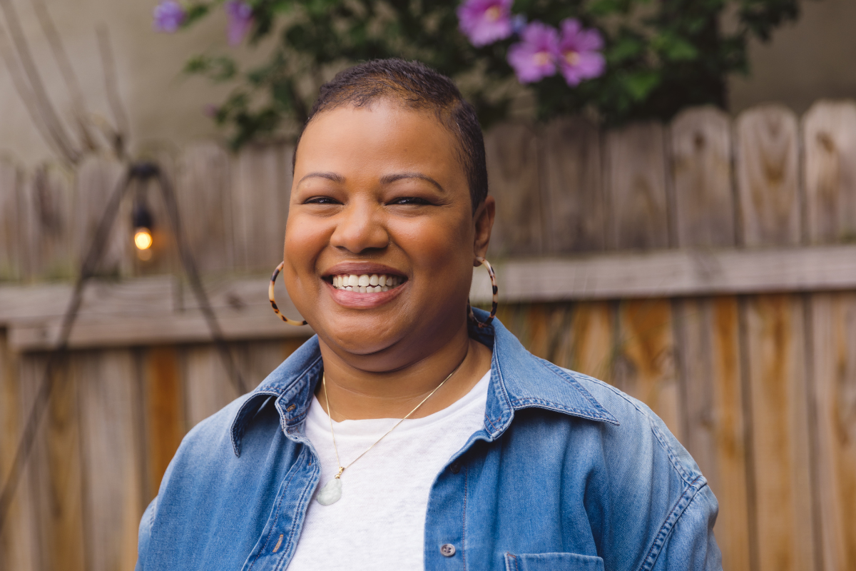 Woman standing outside, smiling
