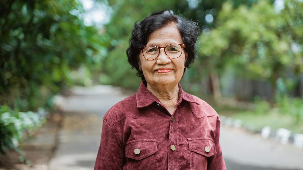 An elderly asian woman looking stoic