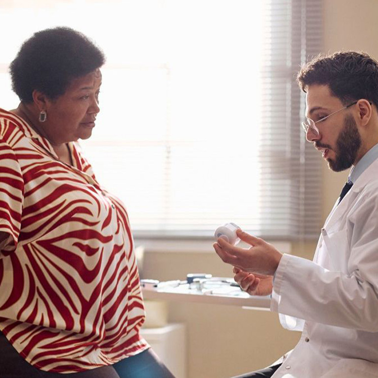 A Black woman and a male doctor in a conversation