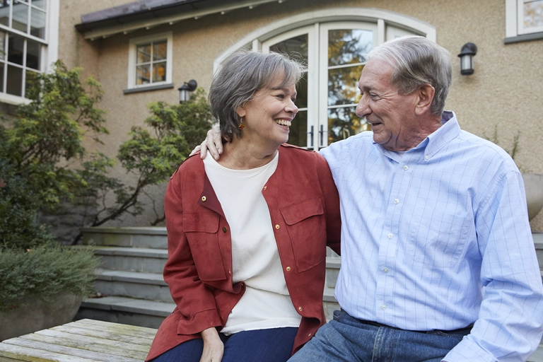 Older white, heterosexual couple, looks at each other lovingly