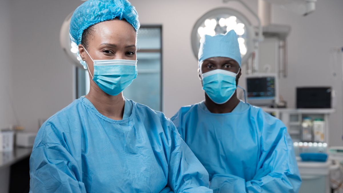 Two Black doctors in scrubs in a surgical suite