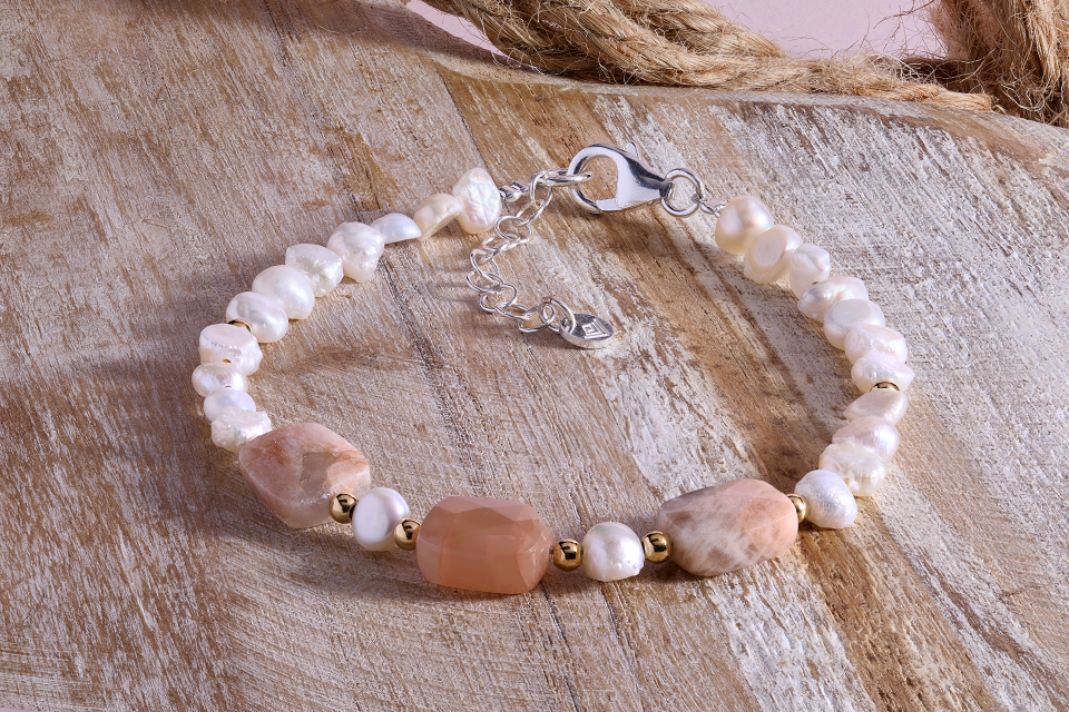 A bracelet with pink rocks on it