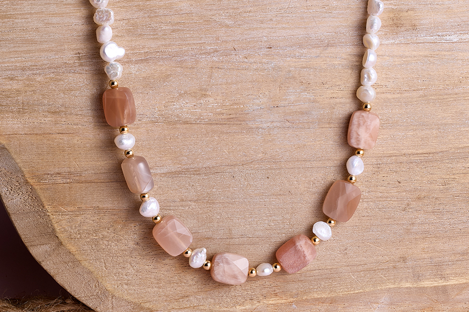 A necklace with pink rocks on it
