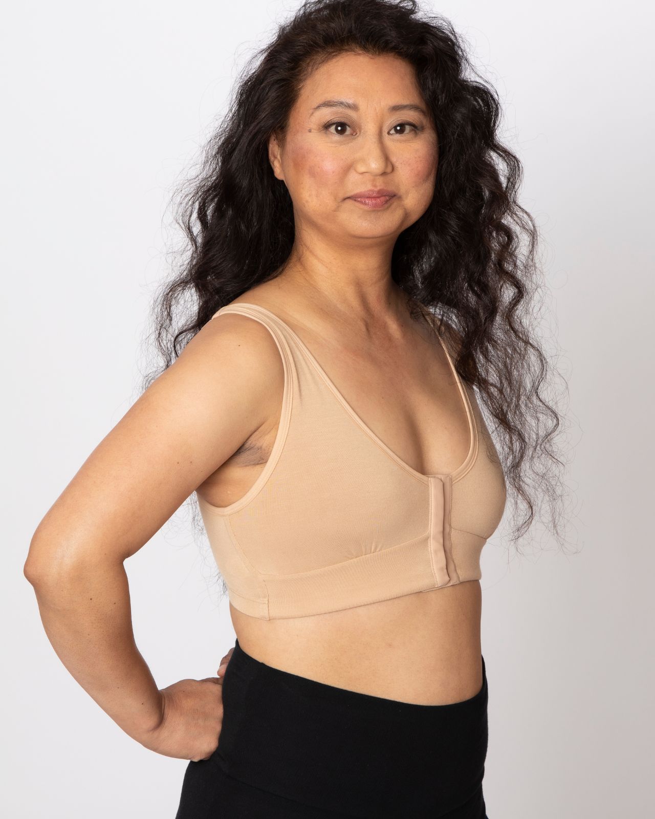 Asian woman wearing a tan bra