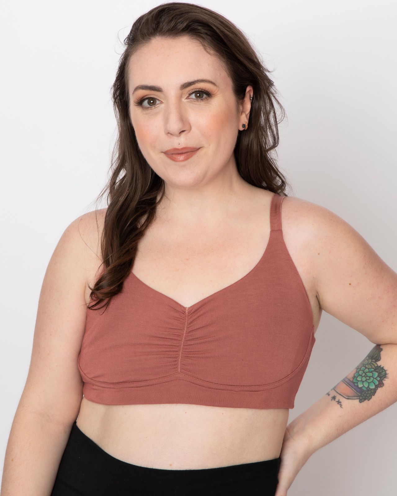 White woman wearing a rose colored bra