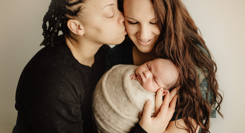 A multiracial lesbian couple with their baby