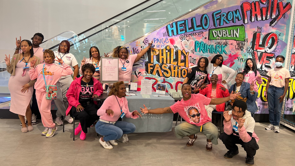 A group of Black women and men gathered around an LBBC table