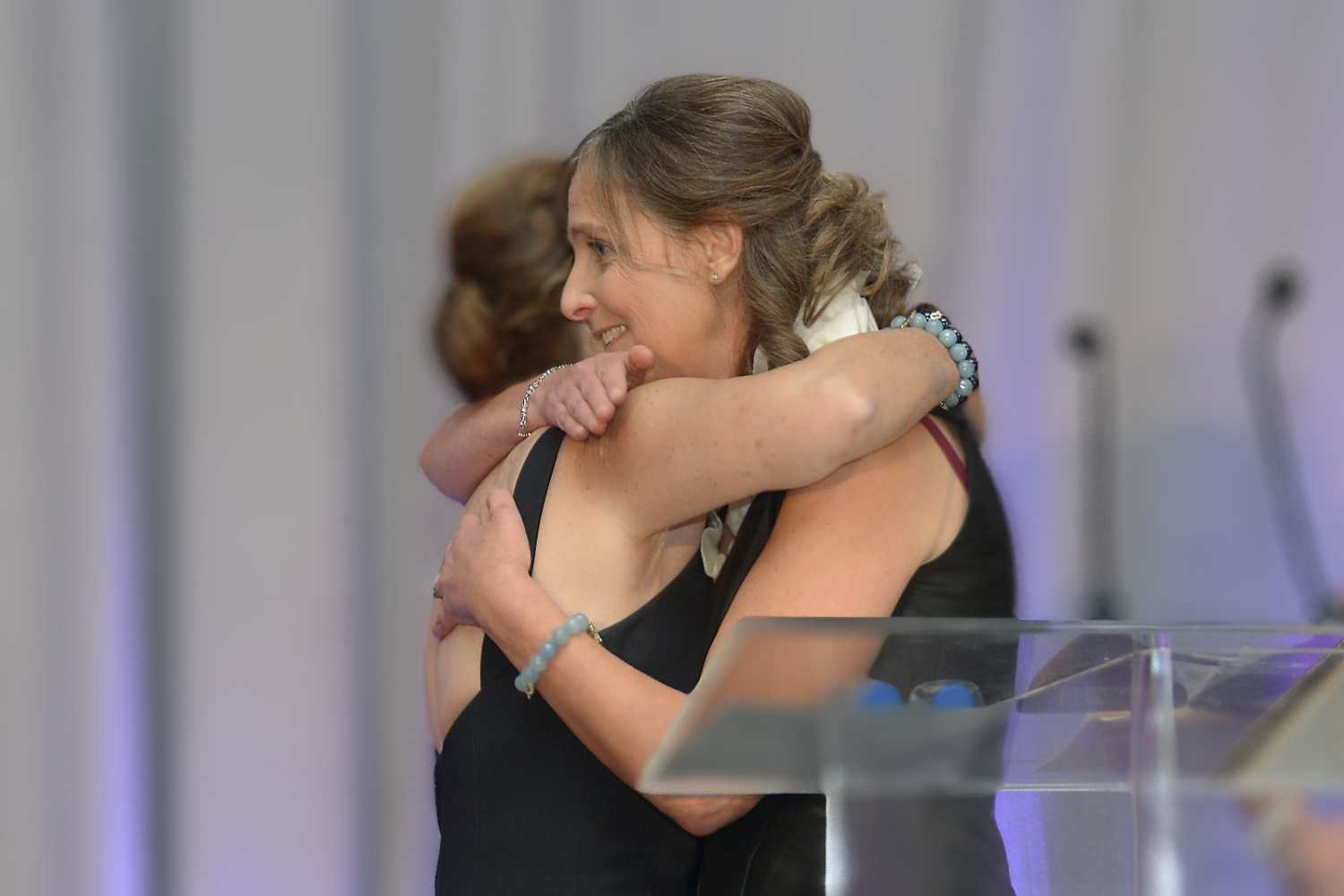 Jean Sachs hugging woman