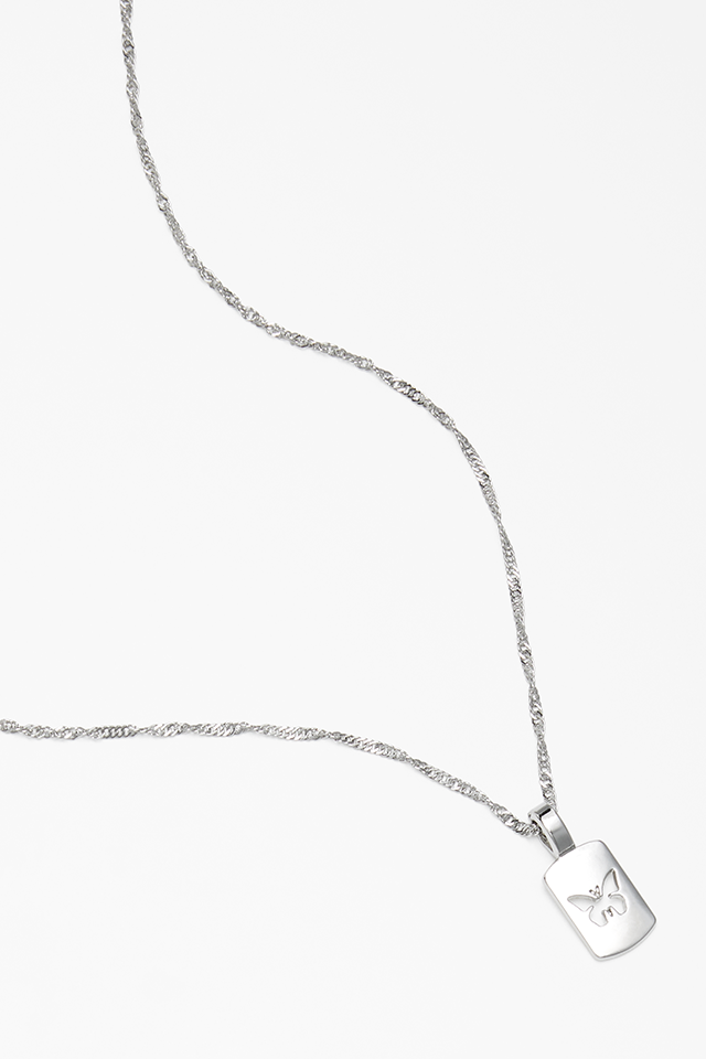 A silver necklace with the imprint of a butterfly.