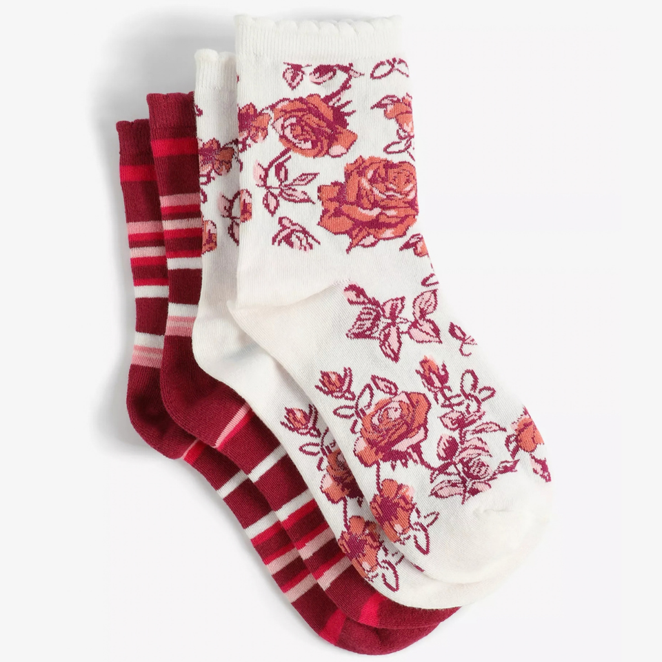 Two pairs of socks. One had pink and white stripes, the other has pink flowers