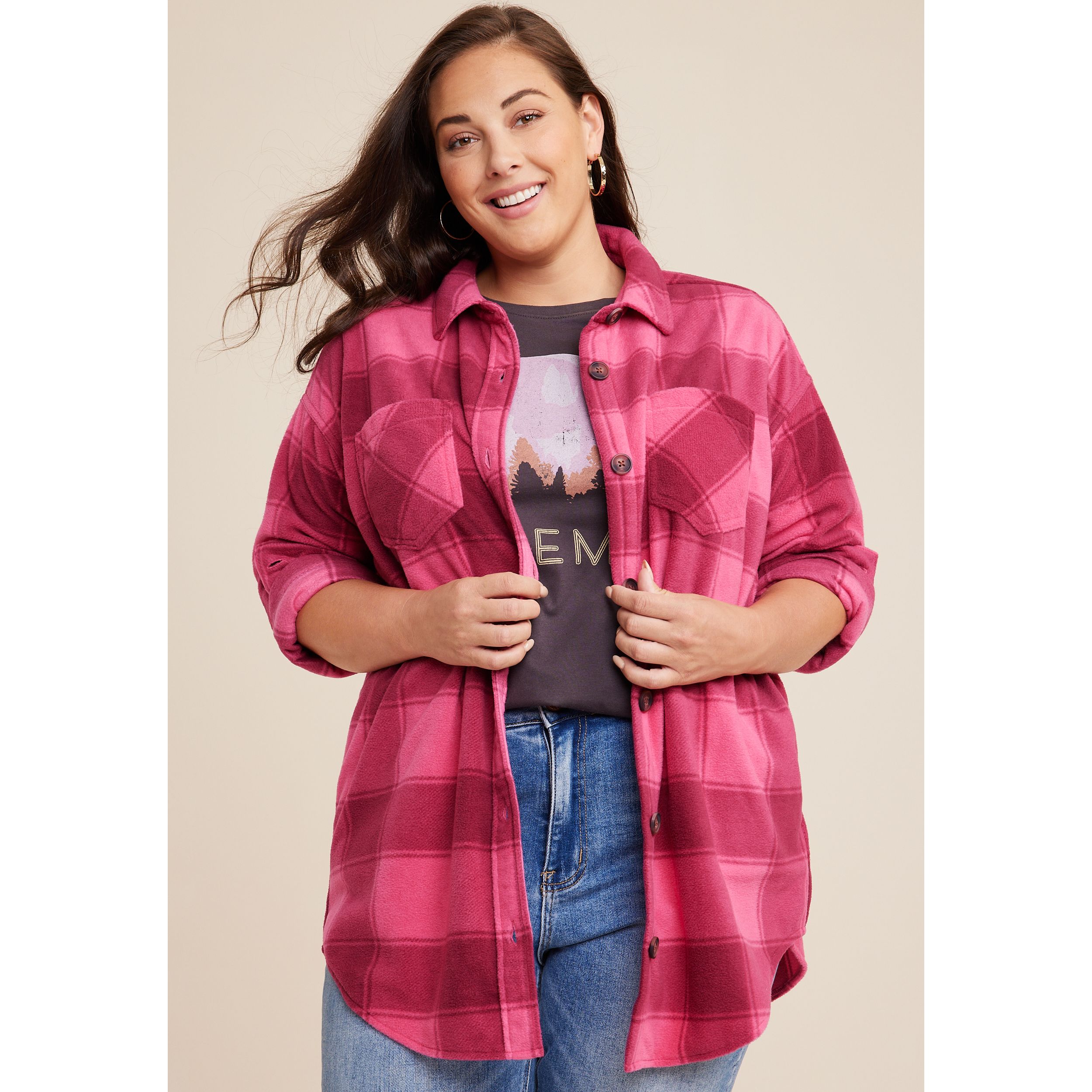 woman smiling wearing a pink flannel