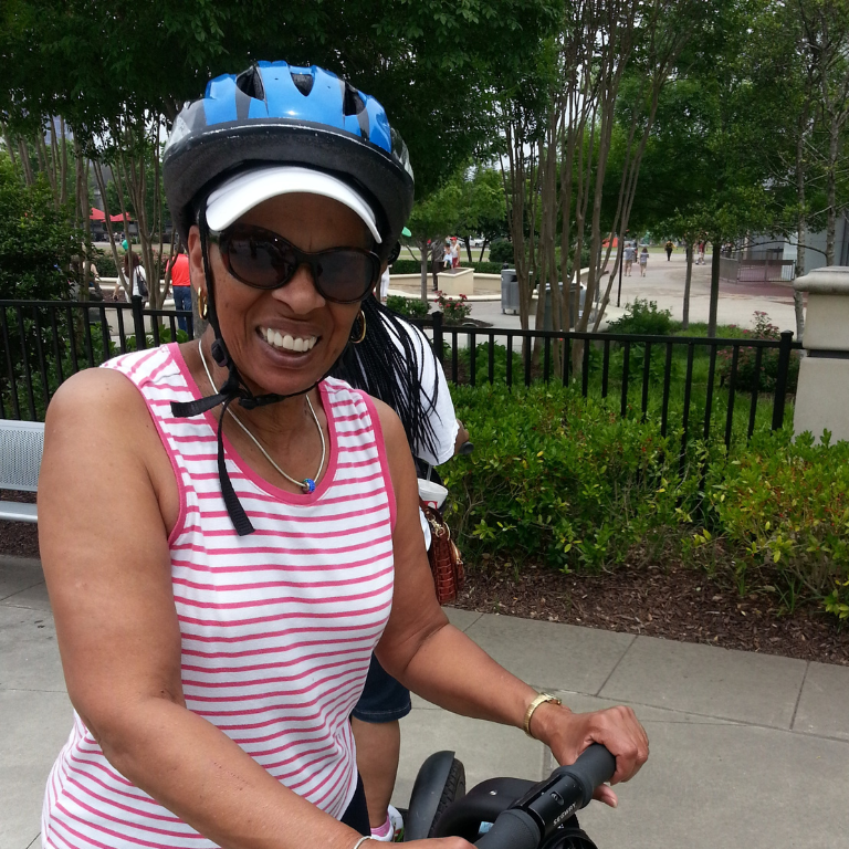 Marcella Palmer riding a motorized device with a helmet on