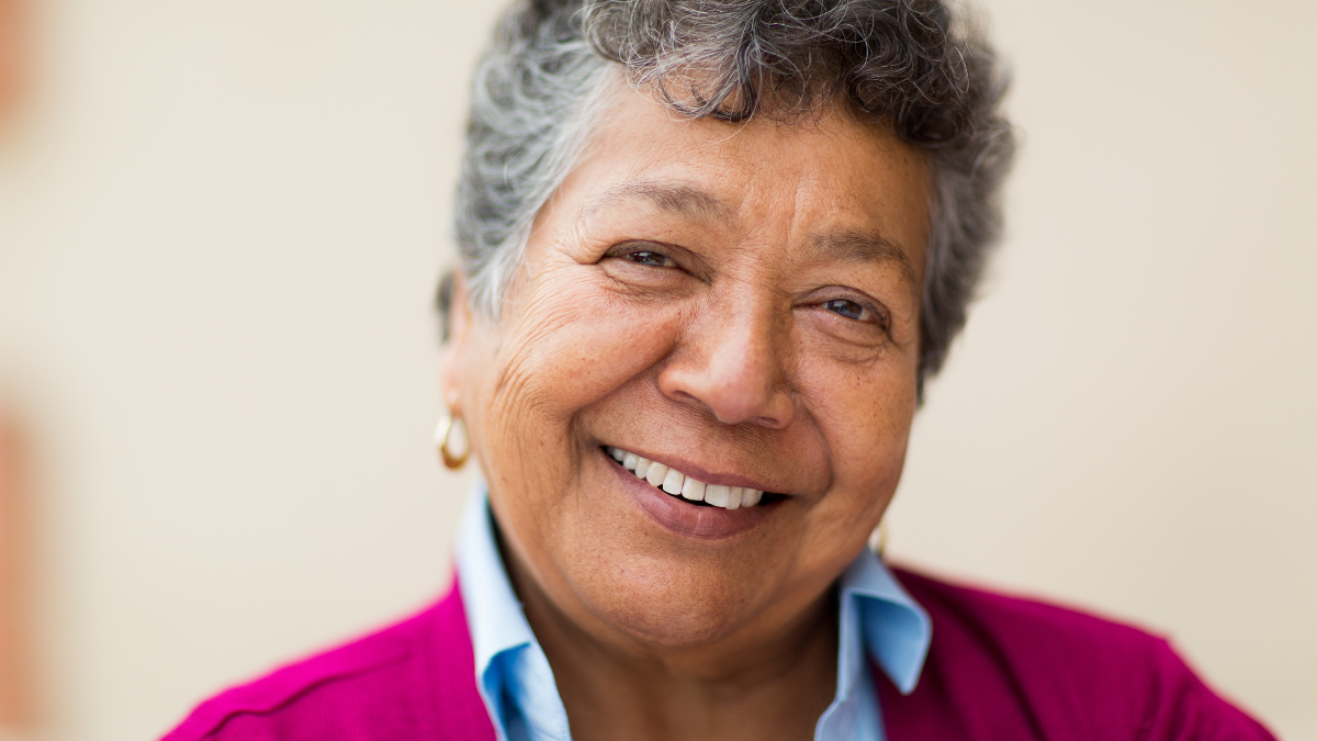An elderly Hispanic woman smiling