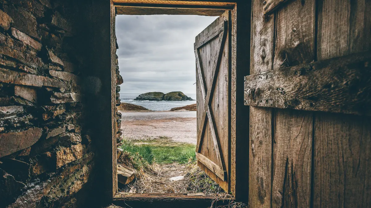Rustic door opens to the sea