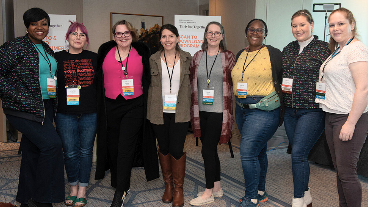 A diverse group of women smiling, wearing their name badges at the 2025 mets conference.