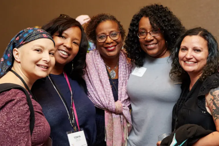 Five women, 3 Black and 2 white, pose for a picture at the annual metastatic breast cancer conference