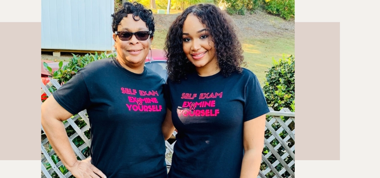 Two Black women, a mother and daughter, both wearing shirts saying "Self Exam / Examine Yourself"
