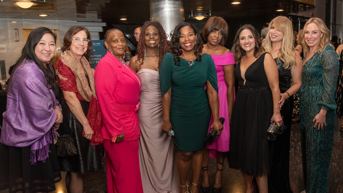 A group of diverse women in formal clothes pose for a photo at the 2022 Butterfly Ball