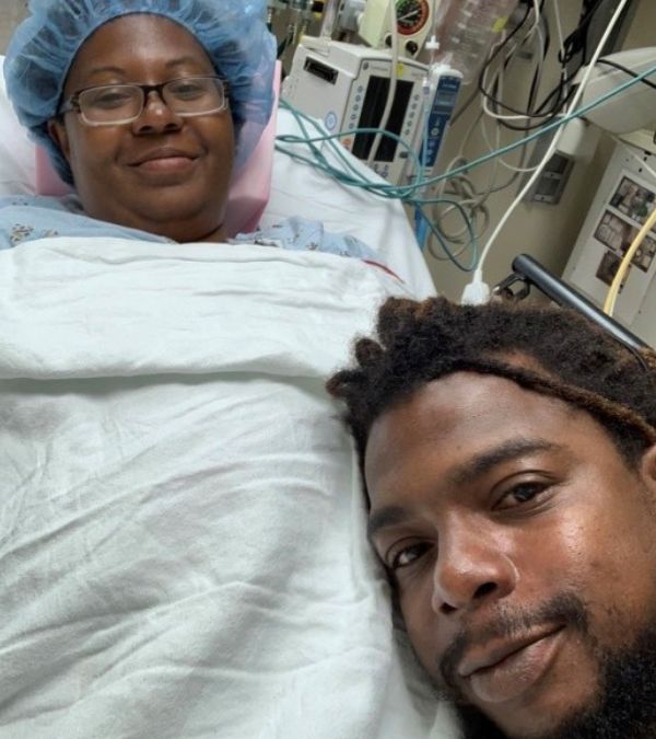 Cheryl and her husband on hospital bed