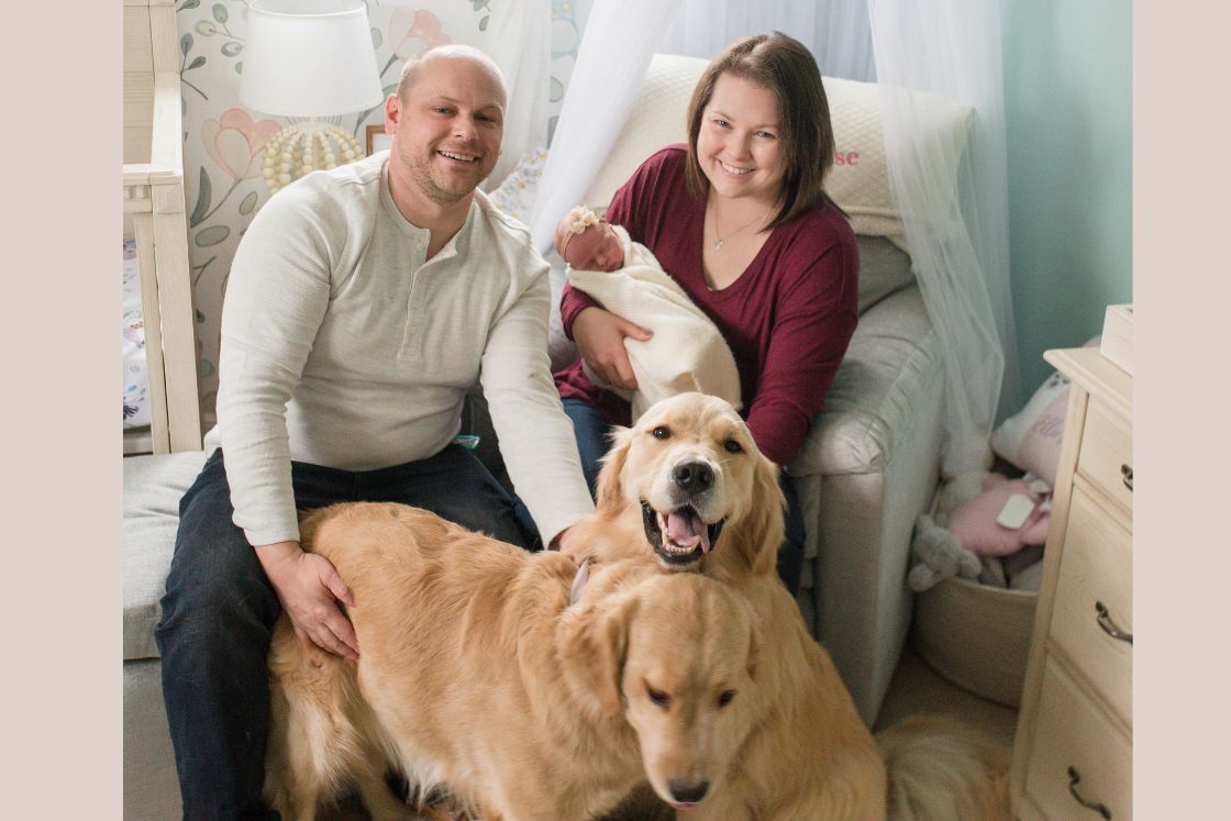 Meghan, her husband, their infant and two golden retreivers