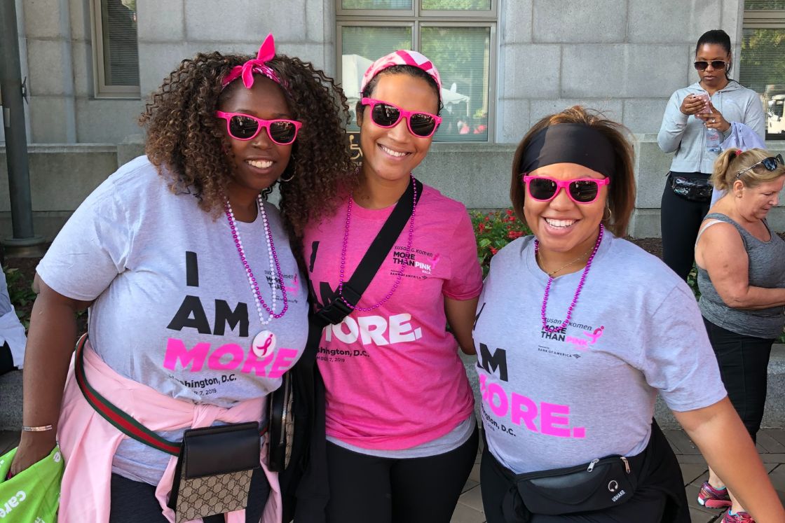 A young breast cancer survivor and her co-workers at a breast cancer fundraiser