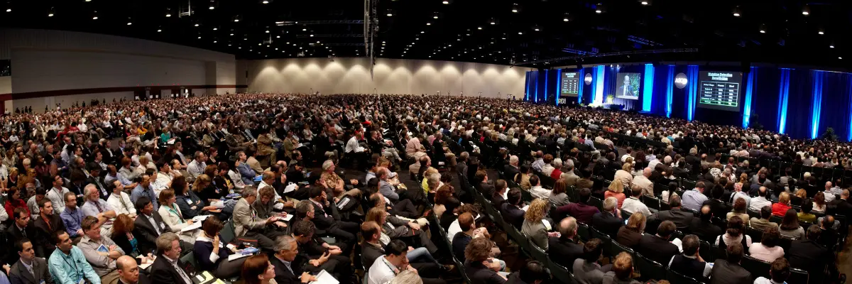 A large crowd of people attend a talk at ASCO