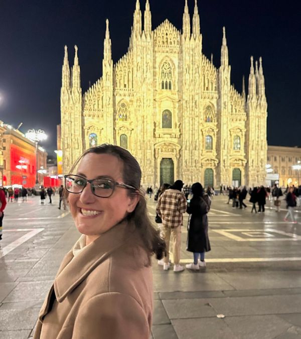 Lisa Francis stands in front of a golden catedral in Switzerland