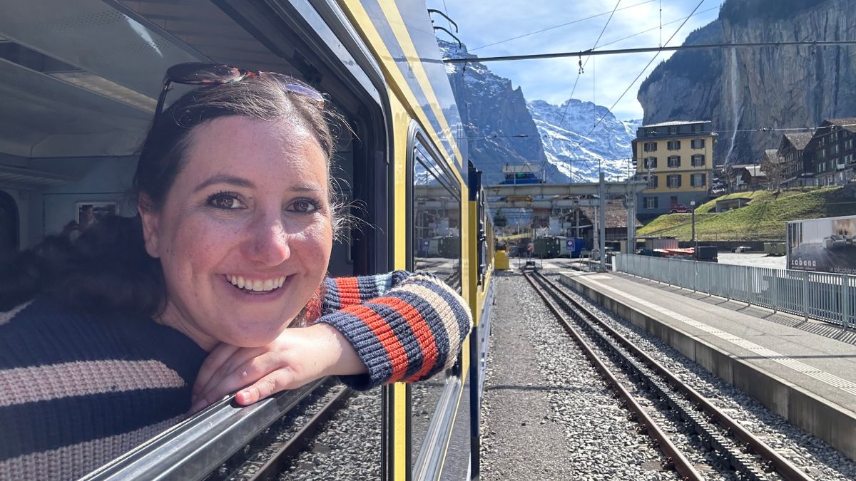 Lisa Francis pokes her head out of a train window in Switzerland