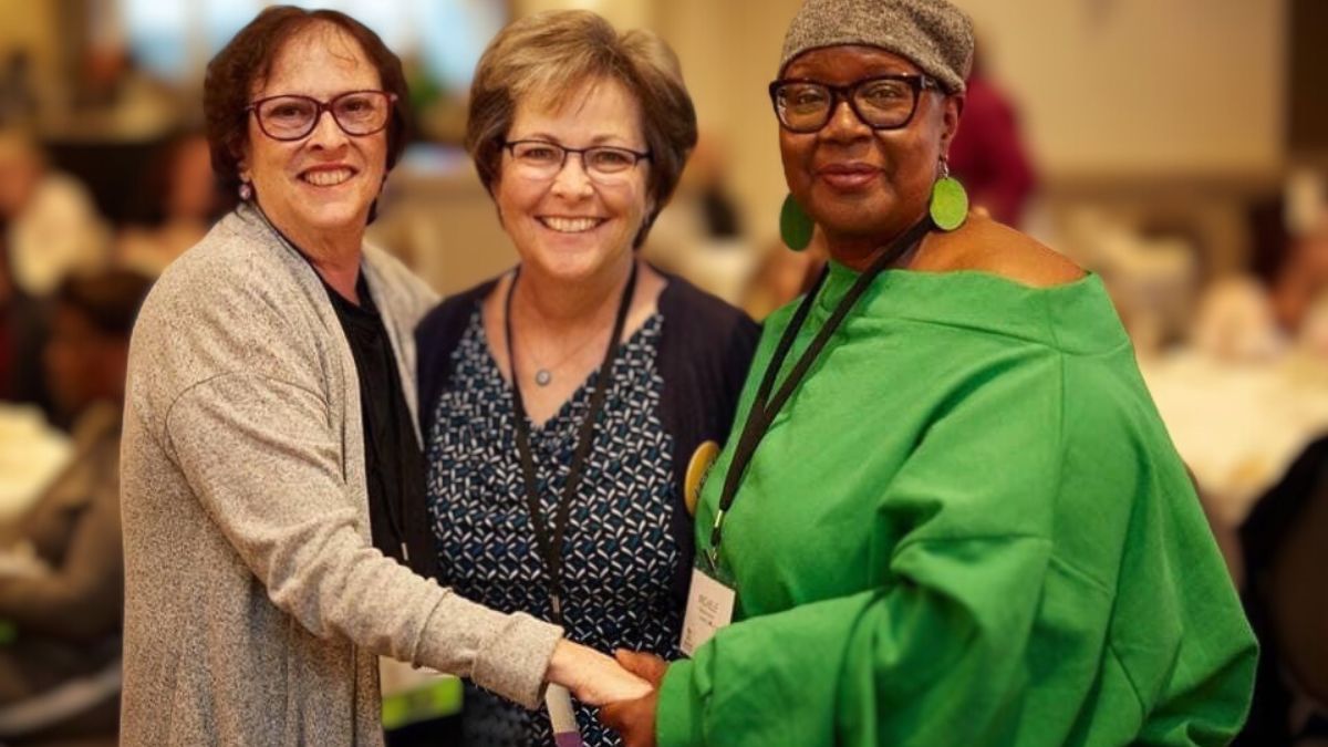 Janice Cowden surrounded by two female friends