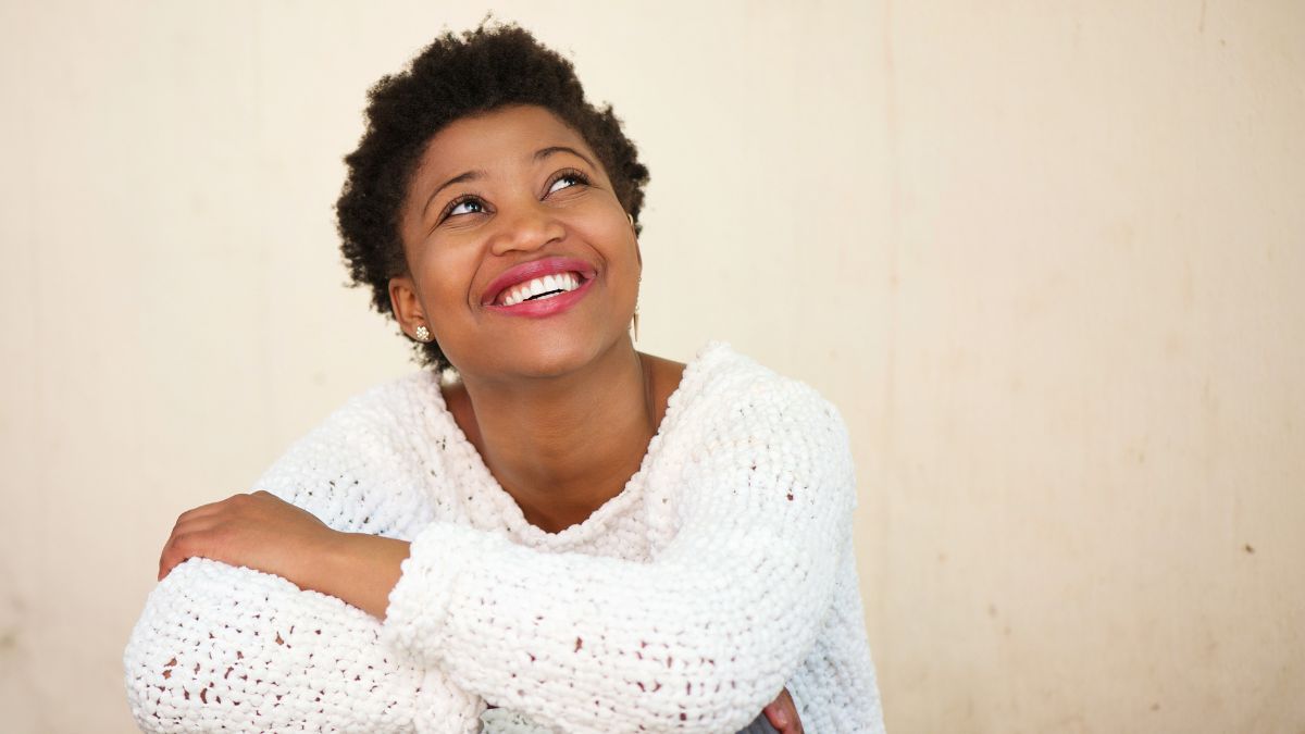 Black woman smiling and looking up