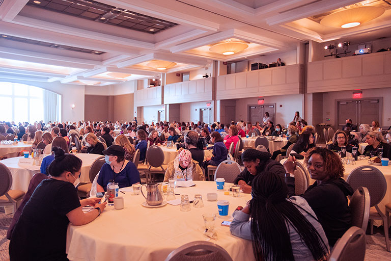 large group of people seated for conference presentation