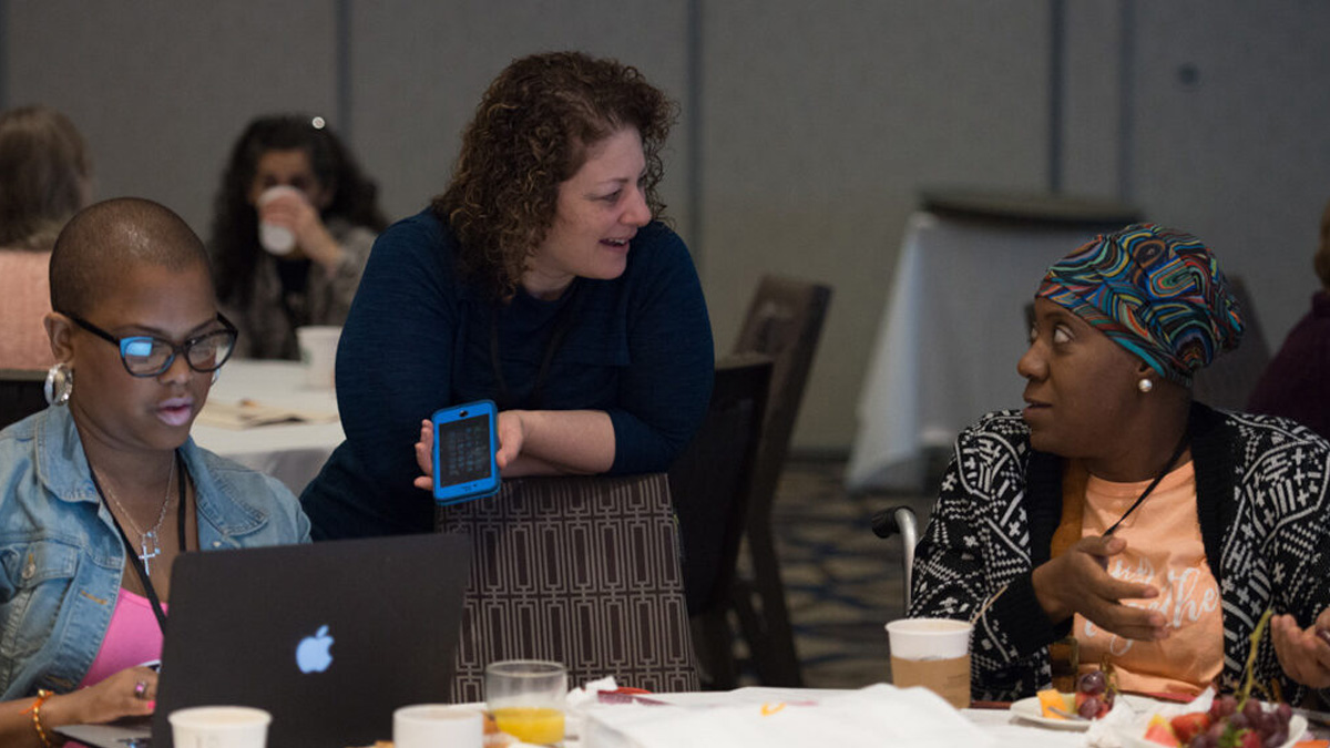 Janine Guglielmino speaks with conference attendees