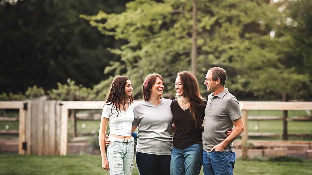 Aliza Feldman, her two daughters, and husband outside a rural setting