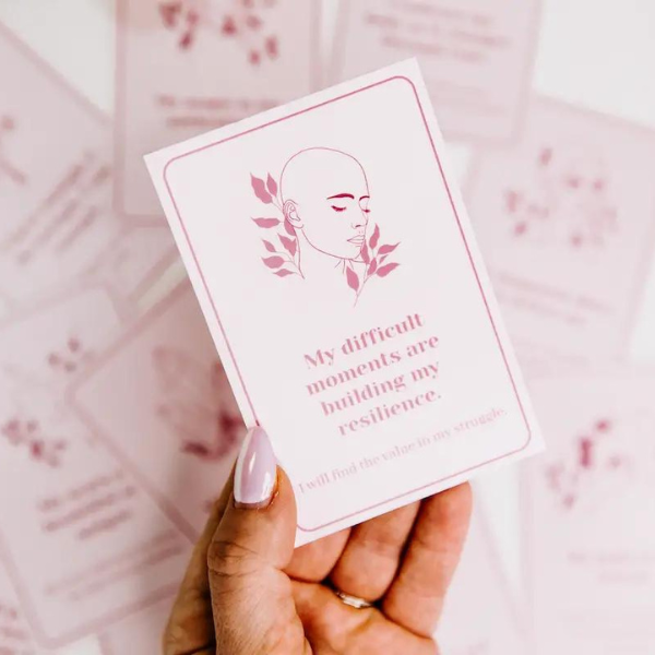 Hand holding affirmation card from Cancer Chic